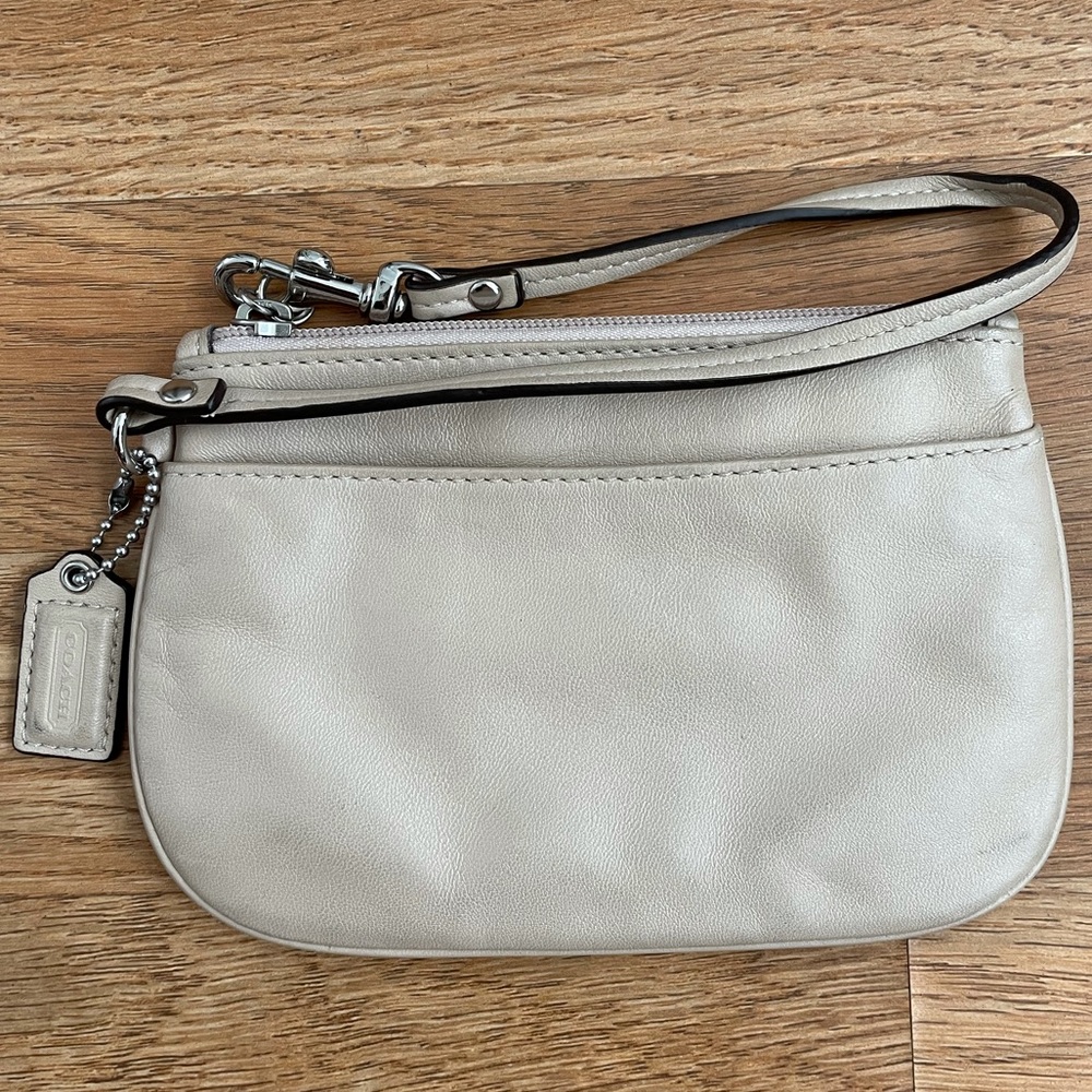 cream-colored coach wristlet
